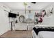 Bright bedroom features a large dresser with mirror, window, and beige carpeting at 3545 W Tanner Ranch Rd, San Tan Valley, AZ 85144