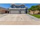 Inviting two-story home with a large driveway and attached two-car garage at 3545 W Tanner Ranch Rd, San Tan Valley, AZ 85144