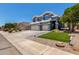 View of home's exterior with spacious driveway and landscaped front yard at 3545 W Tanner Ranch Rd, San Tan Valley, AZ 85144
