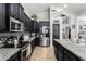 Modern kitchen with stainless steel appliances, dark cabinetry, and a sleek design at 3545 W Tanner Ranch Rd, San Tan Valley, AZ 85144
