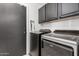 Laundry room with appliances, storage cabinets, and access door to exterior at 3545 W Tanner Ranch Rd, San Tan Valley, AZ 85144