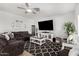 Bright living room featuring a cozy sectional, decorative rug, and modern entertainment center at 3545 W Tanner Ranch Rd, San Tan Valley, AZ 85144