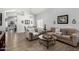 Open-concept living room with warm tones, hardwood floors, and natural light at 3545 W Tanner Ranch Rd, San Tan Valley, AZ 85144