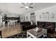 Open-concept living area with a large sectional sofa, kitchen access, and dining space at 3545 W Tanner Ranch Rd, San Tan Valley, AZ 85144