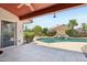 Entertainer's backyard with pebble-tec pool, water feature, covered patio, and lush landscaping at 4428 E Yawepe St, Phoenix, AZ 85044