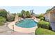 Backyard with a pool, mature landscaping, and stone accents at 4428 E Yawepe St, Phoenix, AZ 85044