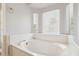 Primary bathroom with a large garden tub with large window at 4428 E Yawepe St, Phoenix, AZ 85044