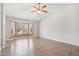 Bright bedroom featuring a large bay window and wood-look flooring at 4428 E Yawepe St, Phoenix, AZ 85044