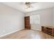 A bedroom featuring a wooden bookcase, tile flooring, and a bright window at 4428 E Yawepe St, Phoenix, AZ 85044