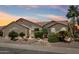 Well-manicured desert landscaping with a charming home and beautiful sunset sky at 4428 E Yawepe St, Phoenix, AZ 85044