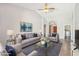 Bright, stylish living room with vaulted ceilings, comfortable seating, a ceiling fan, and contemporary decor at 4428 E Yawepe St, Phoenix, AZ 85044