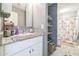 Bathroom features a single sink vanity, granite countertops, and a rainbow shower curtain at 45173 W Sandhill Rd, Maricopa, AZ 85139