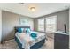 This bedroom features neutral walls, carpet, and a window with plantation shutters at 45173 W Sandhill Rd, Maricopa, AZ 85139