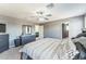 Well-lit Primary bedroom boasts ceiling fan and dark gray dressers at 45173 W Sandhill Rd, Maricopa, AZ 85139