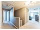 Upstairs hallway featuring carpet, an open railing, and access to bedrooms at 45173 W Sandhill Rd, Maricopa, AZ 85139