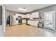 Bright kitchen with white cabinets, stainless steel appliances, and light-colored flooring at 45173 W Sandhill Rd, Maricopa, AZ 85139