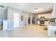 Open kitchen area with stainless steel appliances, white cabinets, and easy access to laundry room at 45173 W Sandhill Rd, Maricopa, AZ 85139