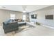 Spacious living room featuring a gray couch and wood floors at 45173 W Sandhill Rd, Maricopa, AZ 85139