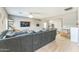 Open-concept living room with couch, TV, and a view into the dining area at 45173 W Sandhill Rd, Maricopa, AZ 85139