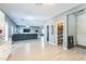 Spacious living room with gray walls and flooring, a large gray sofa, and ample natural light at 45173 W Sandhill Rd, Maricopa, AZ 85139
