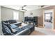 Comfortable living room with plush gray sectional sofa, carpet, and a ceiling fan at 45173 W Sandhill Rd, Maricopa, AZ 85139
