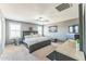 Comfortable bedroom with a gray bed, carpeted floors, and bright windows at 45173 W Sandhill Rd, Maricopa, AZ 85139