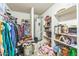 Spacious walk-in closet with ample storage shelves, hanging racks, and a water heater at 45173 W Sandhill Rd, Maricopa, AZ 85139