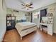 Bedroom with neutral walls, white bed, and light wood look flooring at 4639 W Keim Dr, Glendale, AZ 85301