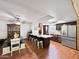 Spacious kitchen with a large island, stainless steel appliances, wooden cabinetry, and hardwood floors at 4639 W Keim Dr, Glendale, AZ 85301