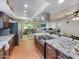 Modern kitchen with granite countertops, stainless steel appliances, a large island, and wood floors at 4639 W Keim Dr, Glendale, AZ 85301
