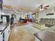 Open concept living room with brick accents, tile flooring, ceiling fans, and neutral colored walls at 4639 W Keim Dr, Glendale, AZ 85301
