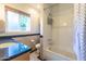 Bathroom featuring a large bathtub and shower combination, tile surround, and granite counters at 4719 N 70Th St, Scottsdale, AZ 85251