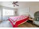 Bedroom featuring a ceiling fan, carpeted floors, and large windows at 4719 N 70Th St, Scottsdale, AZ 85251