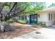 Charming home featuring a blue front door, well manicured landscaping and mature trees at 4719 N 70Th St, Scottsdale, AZ 85251