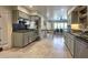 Kitchen with granite counters, stainless appliances, and travertine floors, flowing into the dining area at 4719 N 70Th St, Scottsdale, AZ 85251