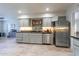 View of kitchen with updated stainless steel refrigerator and dishwasher, and tile flooring at 4719 N 70Th St, Scottsdale, AZ 85251