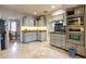 Traditional kitchen with tile flooring, light cabinets, and updated stainless steel microwave and oven at 4719 N 70Th St, Scottsdale, AZ 85251