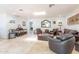 Spacious living room with travertine floors, comfortable seating, and ample natural light from a skylight at 4719 N 70Th St, Scottsdale, AZ 85251