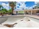 Backyard featuring an empty pool with steps, surrounded by mature trees, and the house in the background at 4719 N 70Th St, Scottsdale, AZ 85251