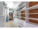 Spacious walk-in closet features custom shelving, cedar planking, and ample storage space for clothes and accessories at 4719 N 70Th St, Scottsdale, AZ 85251