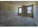 Bedroom space with natural light from two windows, ready for customization and offering a serene retreat at 47705 W Moeller Rd, Maricopa, AZ 85139