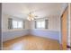 Bedroom with floral wallpaper, wood-look floors, ceiling fan and bright windows at 5228 E Des Moines St, Mesa, AZ 85205