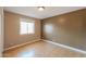 Bedroom featuring window and wood-look floors at 5228 E Des Moines St, Mesa, AZ 85205