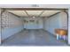 Spacious garage featuring light blue walls, overhead lighting, and concrete flooring, offering ample parking and storage at 5228 E Des Moines St, Mesa, AZ 85205