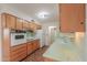 Kitchen features wooden cabinets, vintage appliances, and a tile backsplash at 5228 E Des Moines St, Mesa, AZ 85205