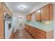 The kitchen boasts ample wooden cabinetry, vintage appliances, and tiled countertops at 5228 E Des Moines St, Mesa, AZ 85205