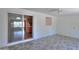 Bright living room featuring gray flooring and views of the kitchen and a window with light coming through at 5228 E Des Moines St, Mesa, AZ 85205