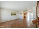 Spacious living room with patterned floors, decorative wallpaper, and built-in wooden shelving at 5228 E Des Moines St, Mesa, AZ 85205