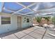 Relaxing covered patio featuring a light blue exterior, neutral furniture, and a mature shade tree at 5228 E Des Moines St, Mesa, AZ 85205