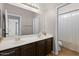 Bright bathroom with a double vanity, large mirror and shower/tub combo at 5402 S 54Th Ln, Laveen, AZ 85339